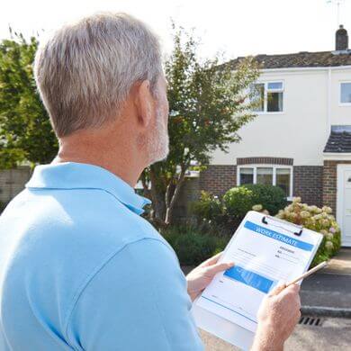 Consultant with a clipboard in front of a home